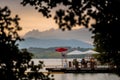 BANYOLES, SPAIN - AUGUST 7 2021: People relaxing on the shores of Lake Banyoles