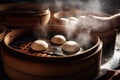 bao bun being carefully separated from its bamboo steamers, with hint of steam still visible