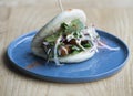 Bao bun with pork belly on a blue plate Royalty Free Stock Photo