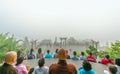 Tourists meditating in front temple as a way to relax soul