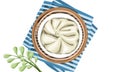 Baozi steamed bun in bamboo basket with plate mat on white background.