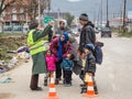 Family of refugees discussing with a NGO volunteer on their way to register and enter Serbia at border with Macedonia