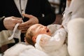 baptism baby. cute little head of a girl under holy water at chr Royalty Free Stock Photo