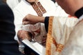 baptism baby. cute little head of a girl under holy water at christening ceremony with priest in church of a girl under holy