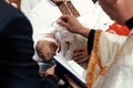 baptism baby. cute little head of a girl under holy water at christening ceremony with priest in church