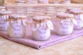 Baptism baby girl shower favors soy candles in glass yogurt jar with floral pattern wrapping, jute ribbon and pink custom label