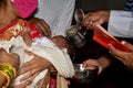 Baptism ceremony in Church. Water is poured on the head of an infant