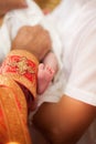 Baptism ceremony , hand of priest holding little baby