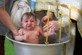 Baptism of a child. Ablution in holy water. Accepting faith. Orthodox baptism Royalty Free Stock Photo