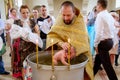 baptism of a child in a christian church in a font