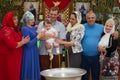 Baptism of the Child. Parents and godparents keep the child at the