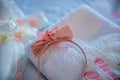 Baptism pictures. A pink baby girl tiara diadem for religious celebration after birth.