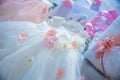 Baptism pictures. White gown baby with pink flowers outfit for religious celebration after birth.