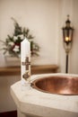 Baptismal candle on font