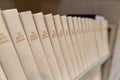 Baptist Hymnal lined up on a shelf, shallow depth of field