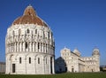 Baptistry and the Leaning Tower in Cathedral Square in Pisa, Italy Royalty Free Stock Photo