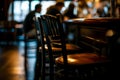 bar chair row with one chair pulled out slightly and person seated