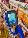 A bar code scanner in a holder on a supermarket trolley in a Tesco store in the UK