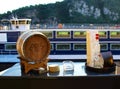 Bar counter with a barrel and a bottle overlooking the ship and the cliff