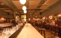 Bar counter of elegant retro cafe with people talking, drinking and having lunch