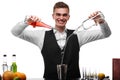 An attractive bartender at a bar counter doing a cocktail, a plate of lime isolated on a white background. Royalty Free Stock Photo