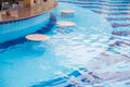 Bar counter in the pool with clear water chairs Royalty Free Stock Photo