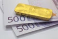 bar of gold and 1000 Euros
