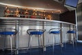Bar interior with round counter and stools Royalty Free Stock Photo