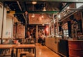 Bar interior with visitors of historical brewery De Koninck, huge beer pub space in Antwerp