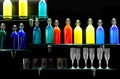 bar with many colored glass bottles without labels with spirits