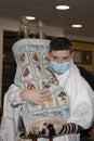 A Bar Mitzvah Boy Holding a Torah Scroll