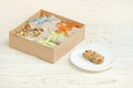 Bar of muesli on a saucer and boxes with bars. White wooden table