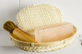 Bar of orange Himalayan crystal Salt Soap on wooden tray with cleaning bath sponge in bathroom. Royalty Free Stock Photo
