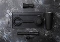 Bar rubber mat with black cocktail shaker,strainer,jigger and plastic stirrers with muddler on black stone background Royalty Free Stock Photo