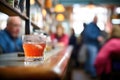 bar scene with negroni in focus, patrons blurred behind