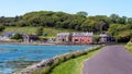 A bar and several houses in a coastal Irish village on a sunny day. Small European village,