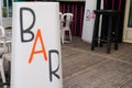 Bar sign text on terrace pub in city street storefront building coffee entrance