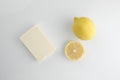 A bar of soap or dry shampoo and lemon isolated on white background Royalty Free Stock Photo