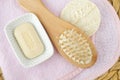 Bar of soap (solid shampoo), wooden hairbrush on the pink towel. Eco friendly toiletries. Natural beauty treatment Royalty Free Stock Photo