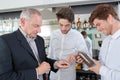 Bar staff inspecting coffee beans Royalty Free Stock Photo