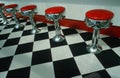 Bar stools and checkered floor in diner