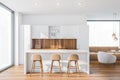 Bar with stools in white and wooden kitchen interior Royalty Free Stock Photo