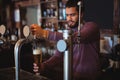 Bar tender filling beer from bar pump Royalty Free Stock Photo