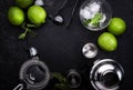 Bar tools. Ingredients for mojito cocktail with lime, mint leaves, ice. Cold drink and beverages preparation. Black table, top Royalty Free Stock Photo