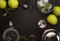 Bar tools. Ingredients for mojito cocktail with lime, mint leaves, ice. Cold drink and beverages preparation. Black table, top Royalty Free Stock Photo