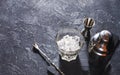 Bar tools for making cocktail. Shaker and a glass of ice on dark stone table. Royalty Free Stock Photo