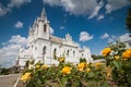 Flowerbed with yellow rose bushes in front of St. Anna Roman Catholic Church, Podillia Neo Gothic architectural masterpiece Royalty Free Stock Photo