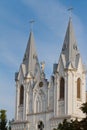 Michael archangel statue on roof and towers with crosses on St. Anna Roman Catholic Church, Christian Gothic Revival temple