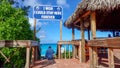 A bar where alcoholic beverages are served at the beach in Half Moon Cay, Bahamas and a sign that says Royalty Free Stock Photo