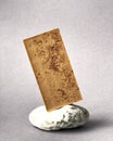 Bar of white chocolate on stone gray background. Side view. Place for text Royalty Free Stock Photo